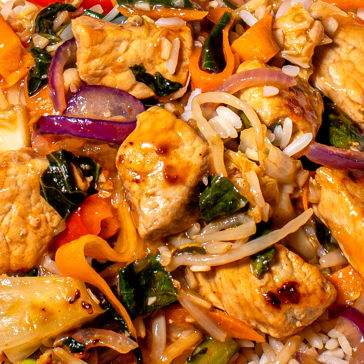 Up close shot of pork sweet and sour stir fry with rice