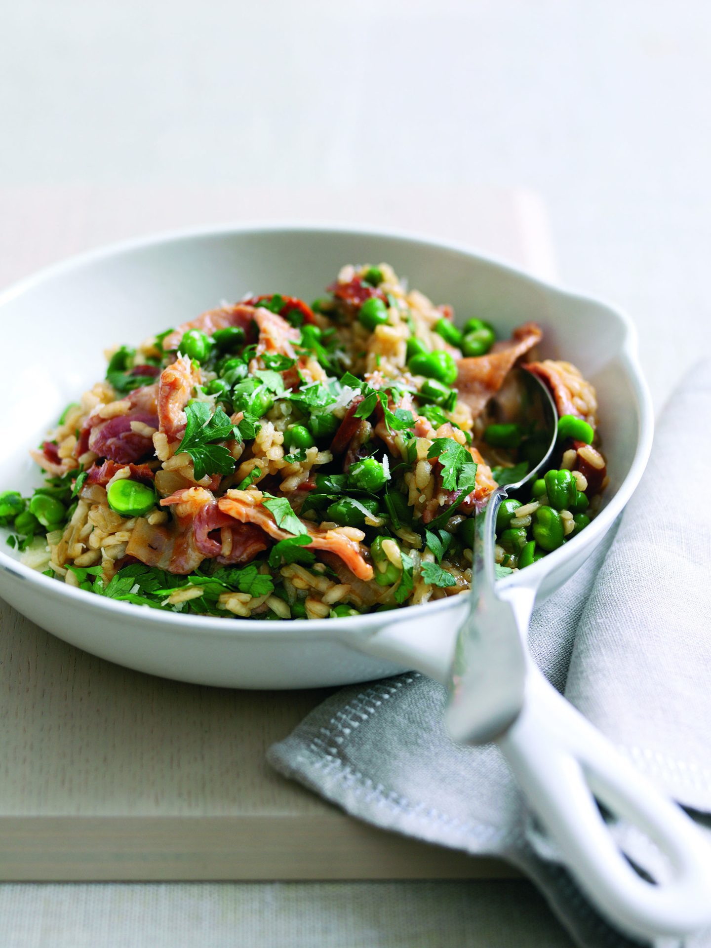 Chorizo risotto with bacon and broad beans served in a bowl