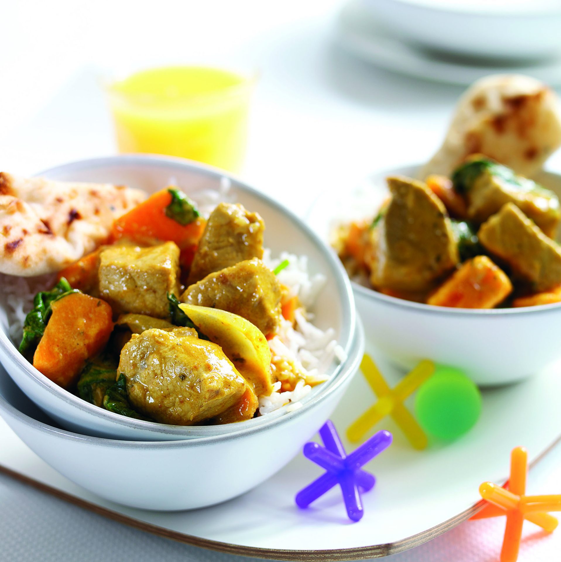 Coconut pork curry served in a white bowl