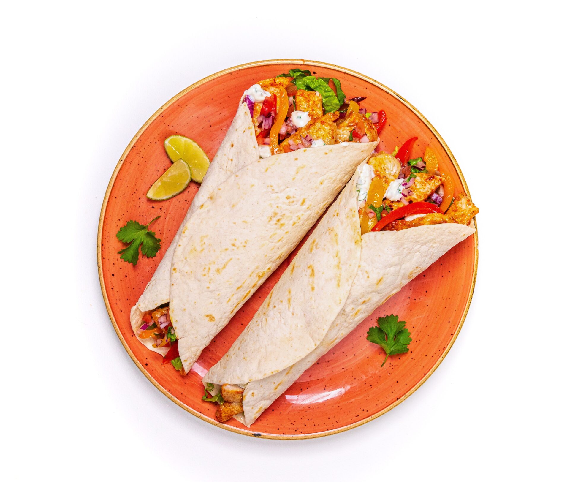 Pork fajitas and vegetables on an orange plate