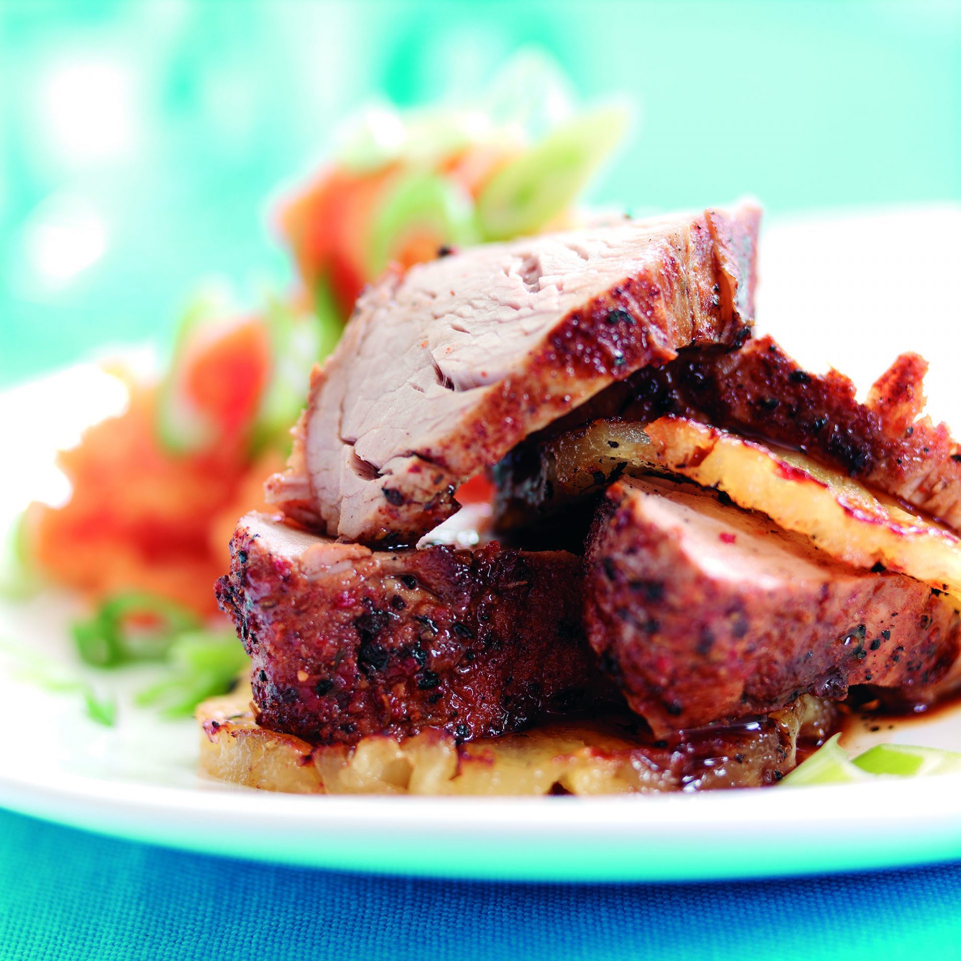 Sliced cajun pork fillet on a white plate