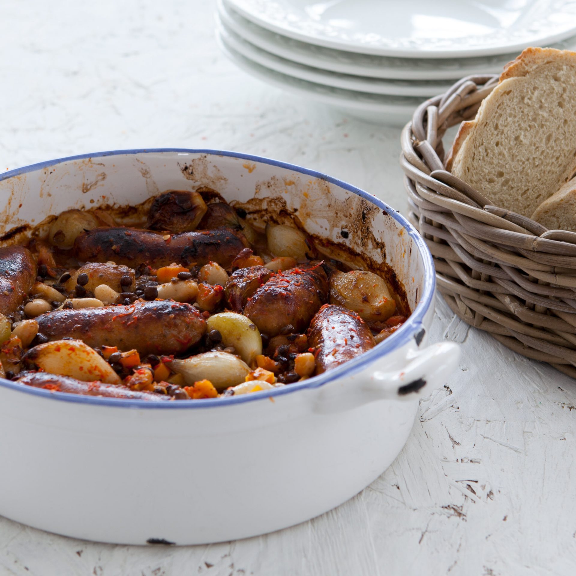 Sausage and lentil casserole in a large white casserole dish