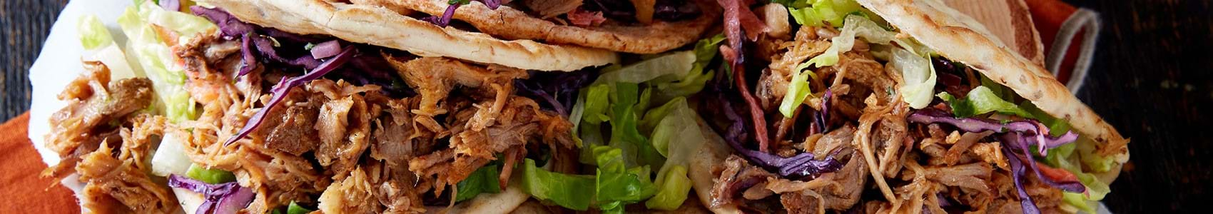 Four flatbreads filled with pulled pork and coleslaw