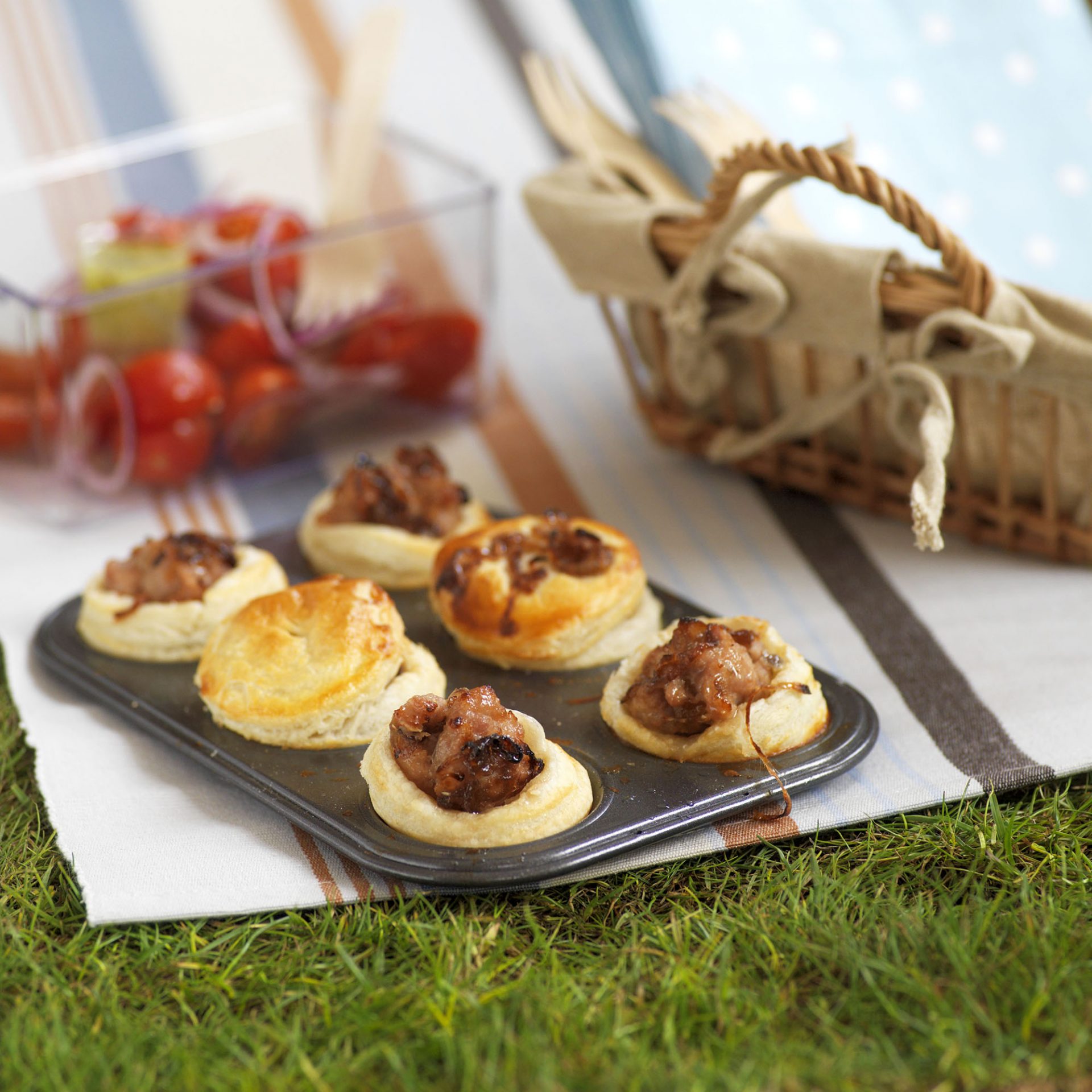 Six mini pork and caramelised onion picnic pies, still in baking tray