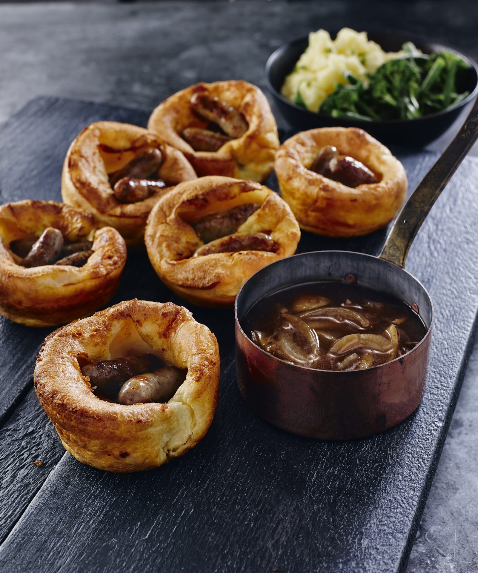 Six mini toad in the holes served on a black board