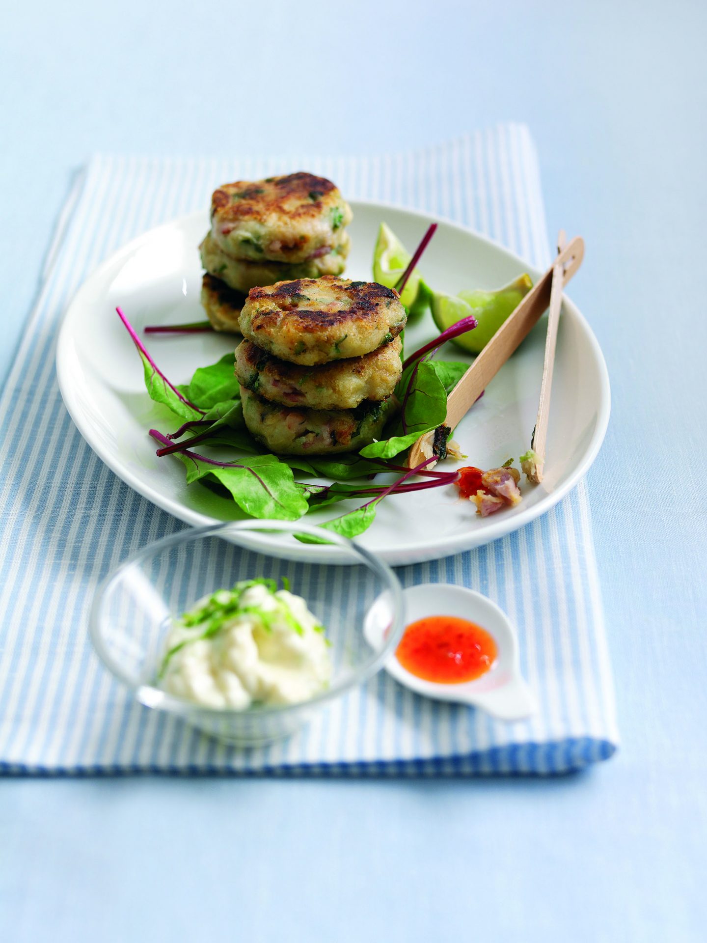 Oak smoked bacon cakes with lime chilli served on a white plate