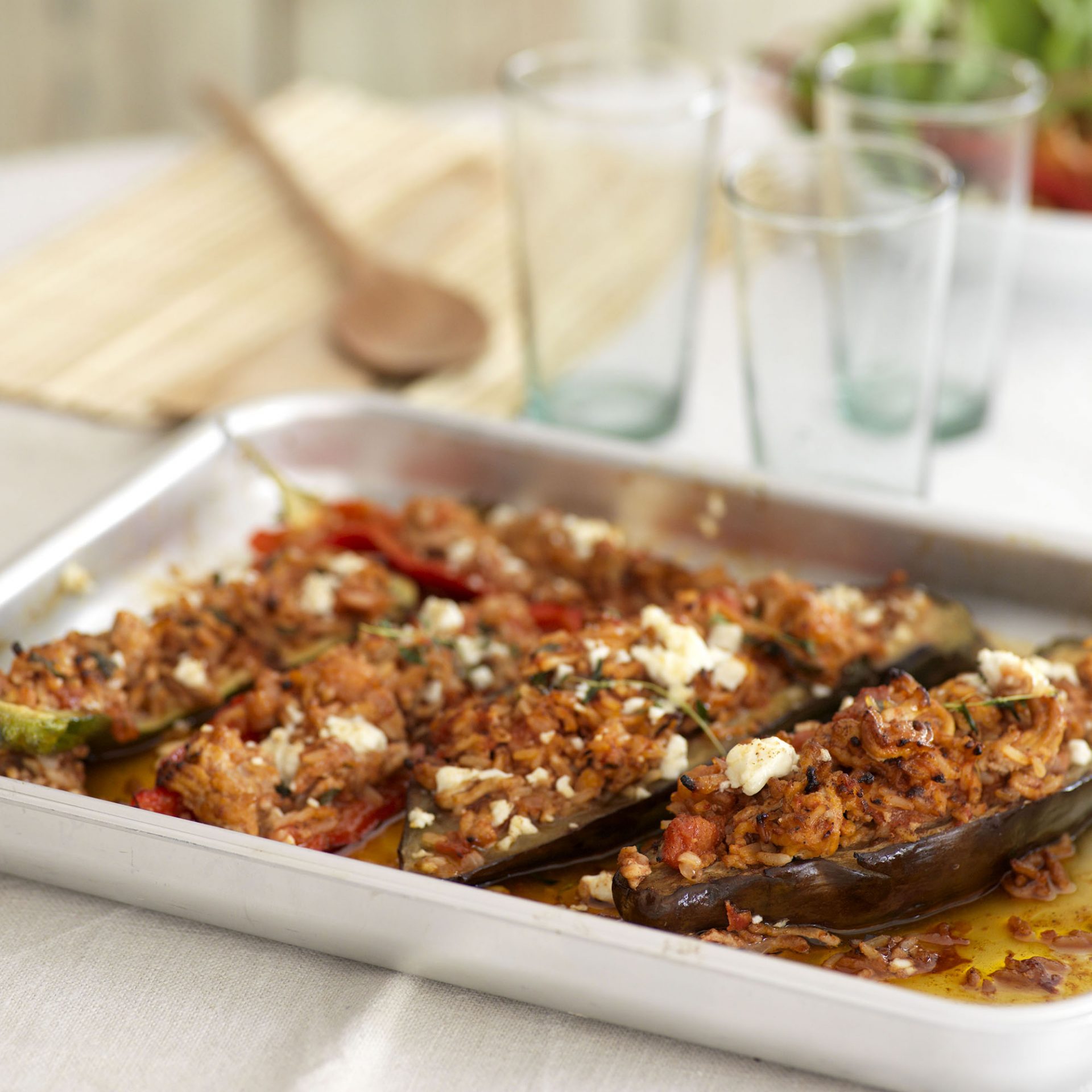 Pork and feta stuffed Mediterranean vegetables on a metal baking tray