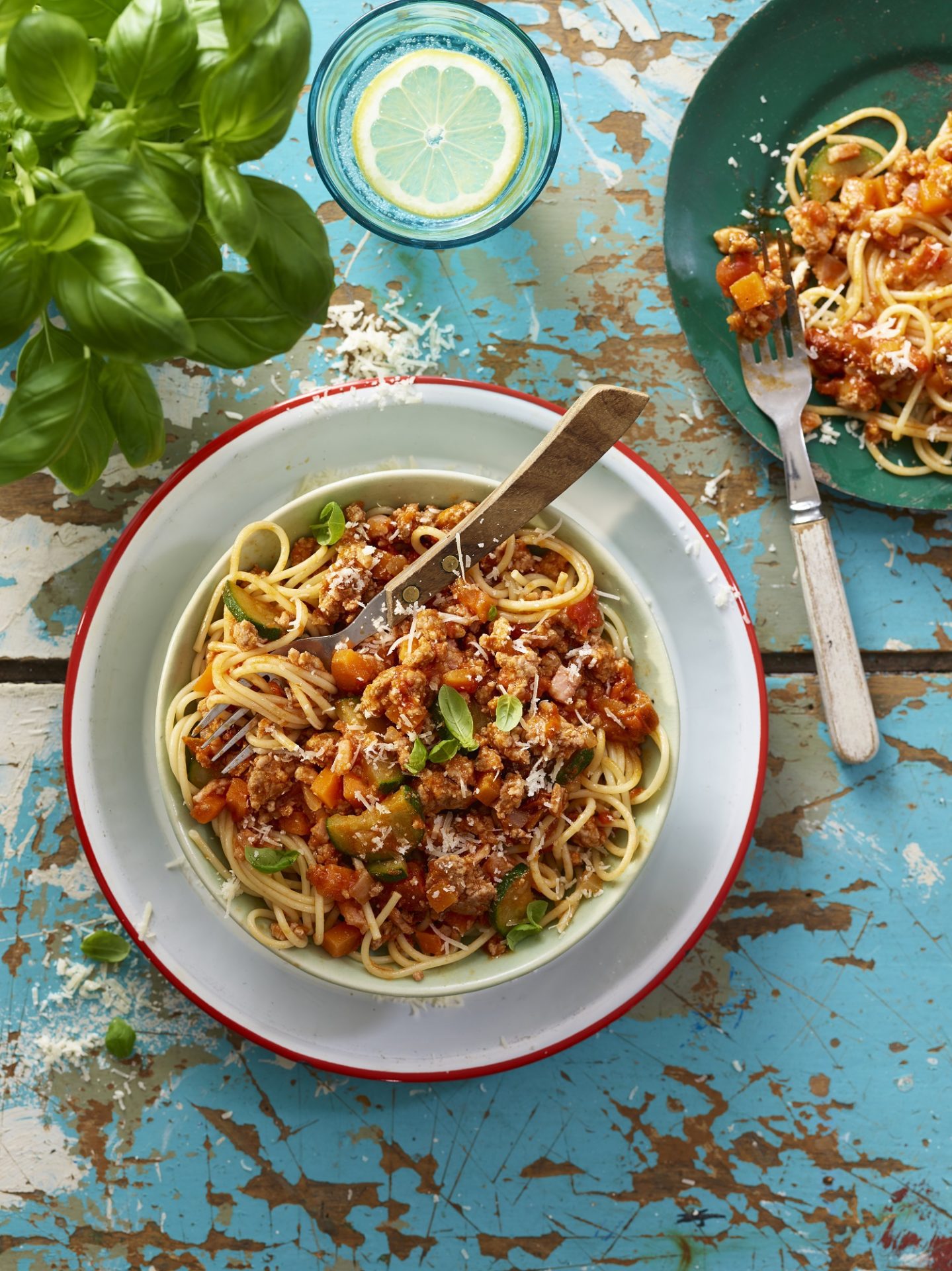 Pork ragu served in a white bowl with cutlery