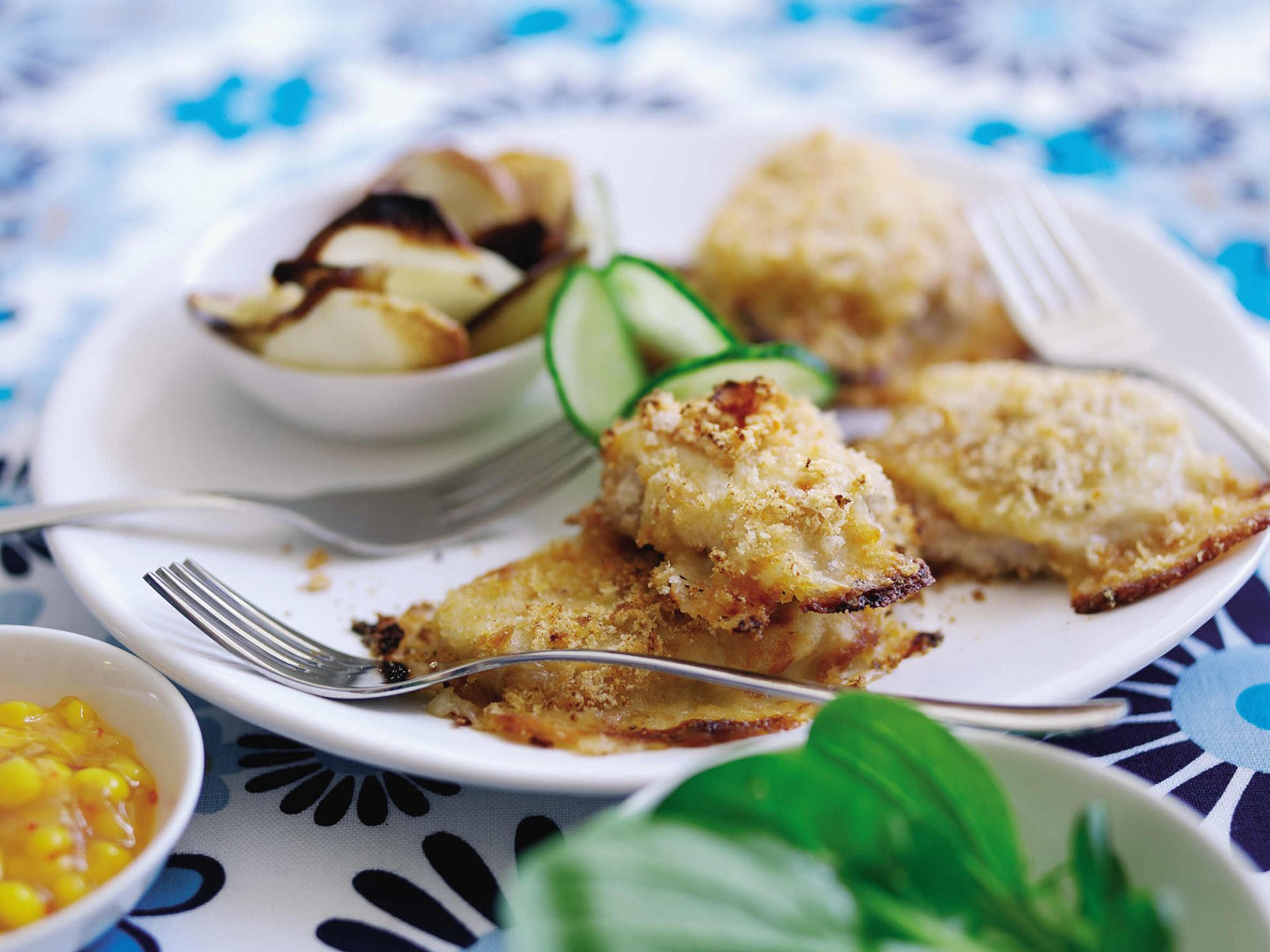 Pork schnitzel bites served on a white plate with fork