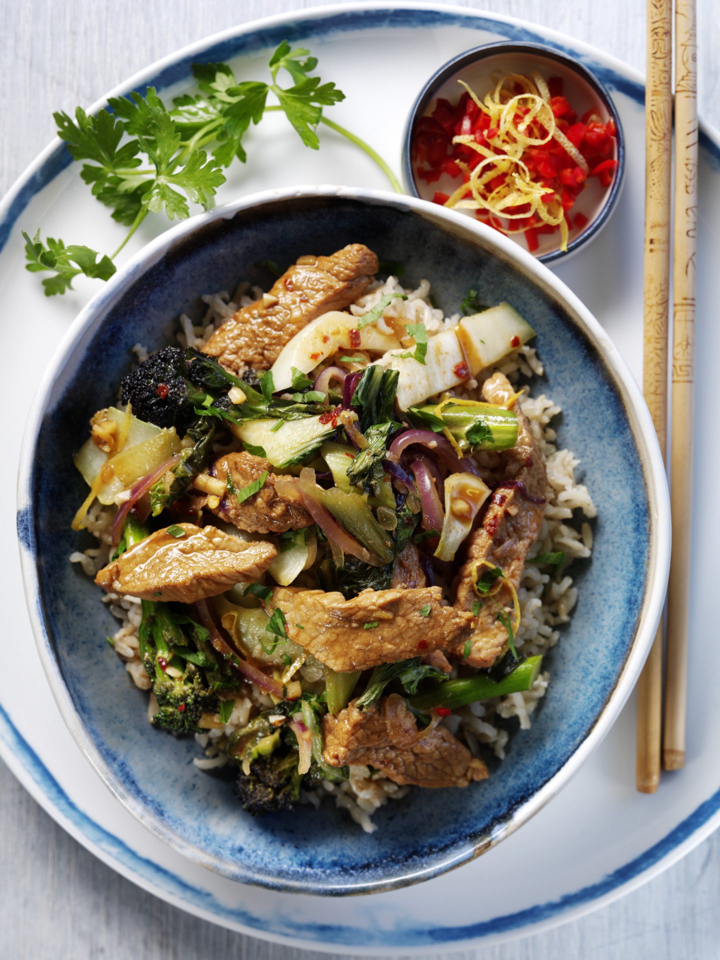 Pork stir fry with pineapple marinade, served in a blue bowl