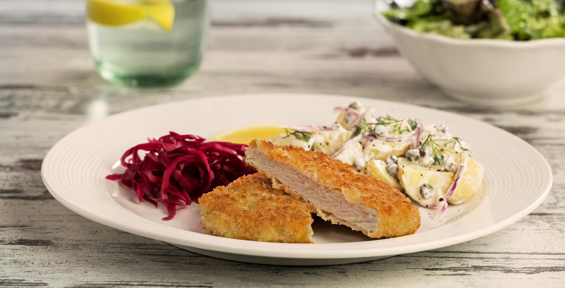 White plate serving a pork schnitzel with red cabbage