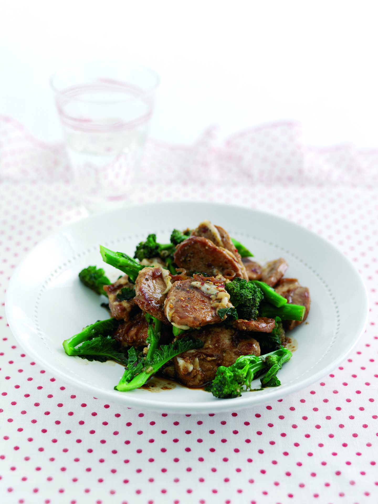 Stir fried soy and honey pork with broccoli, chilli, lemon and goats cheese in a bowl