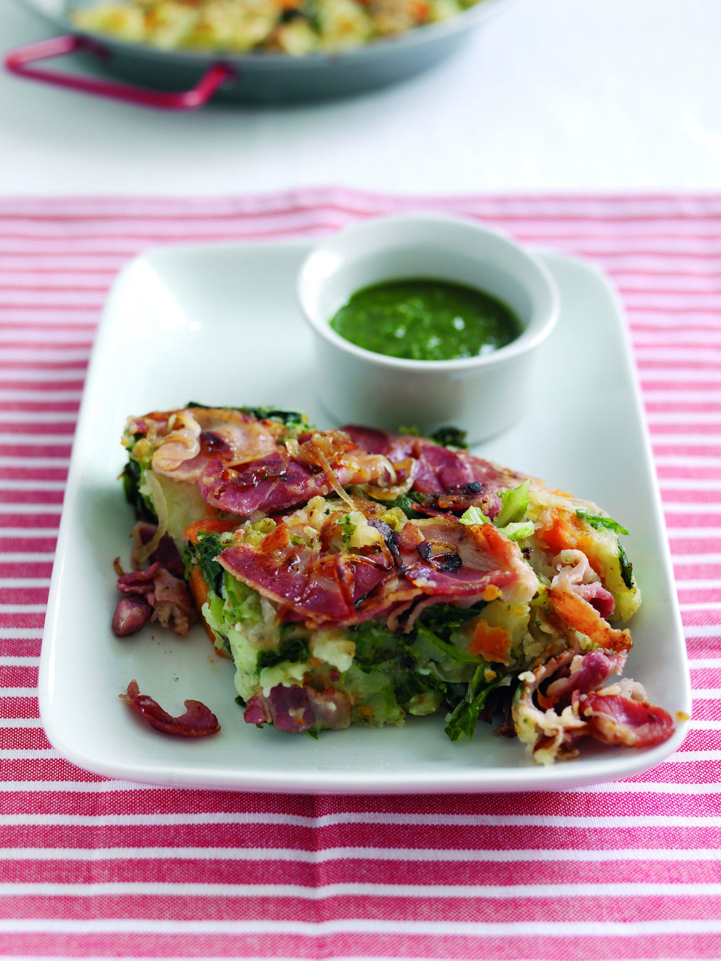 Sweet cured bacon hash with cabbage on a white plate