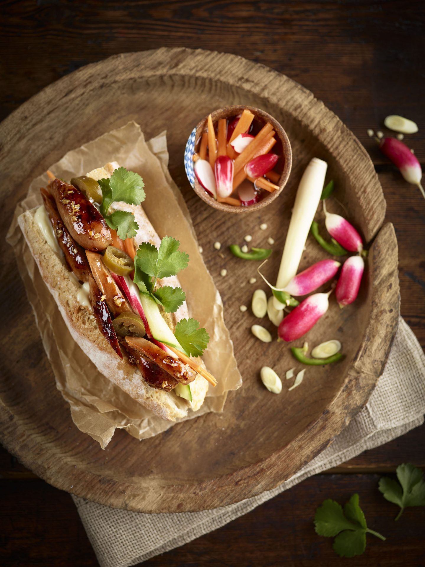 vietnamese sausage sandwich on a wooden circular board