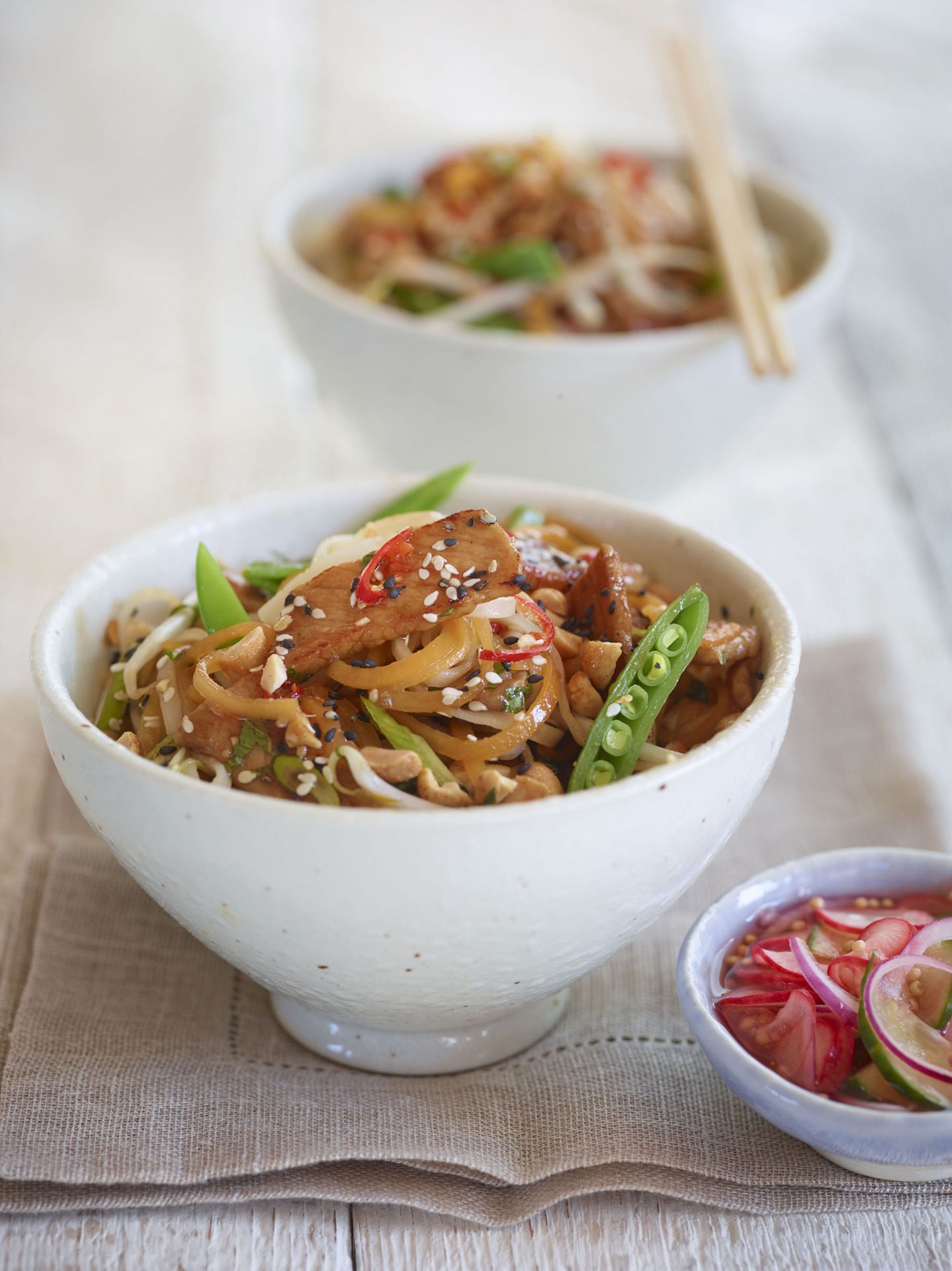 Pork stir fry in a small white bowl