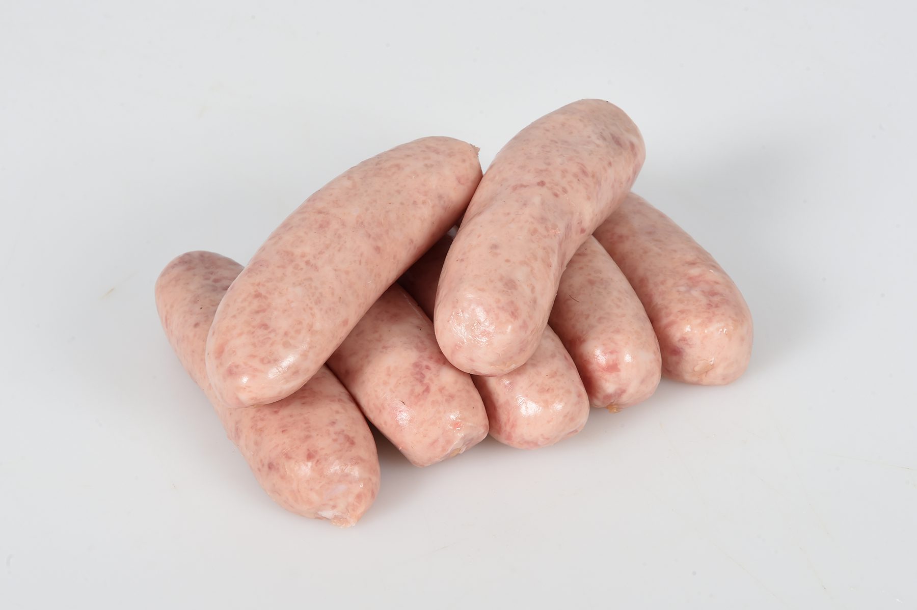 A pile of seven uncooked sausages