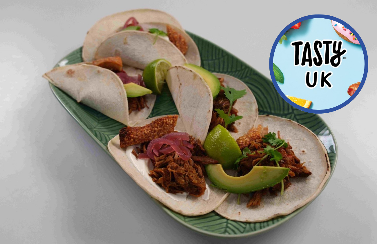 Pork shoulder carnitas in white tortilla wraps with crispy crackling and avocado