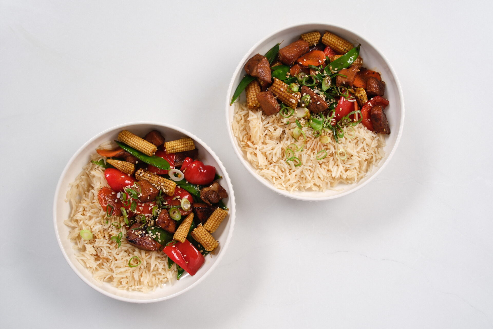 Honey and Garlic Pork Rice Bowl on a white backdrop.