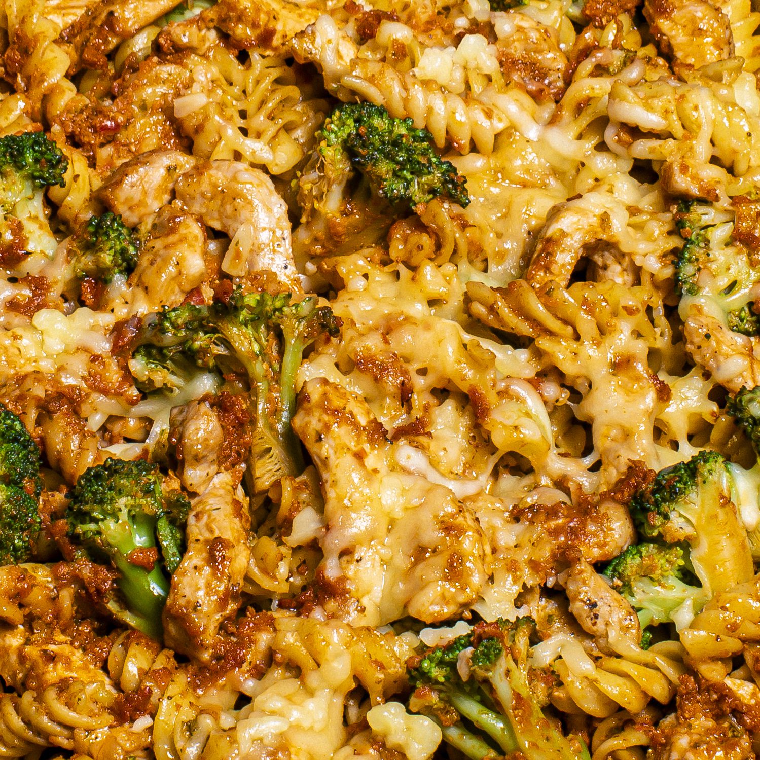 Up close image of pork pesto pasta with broccoli