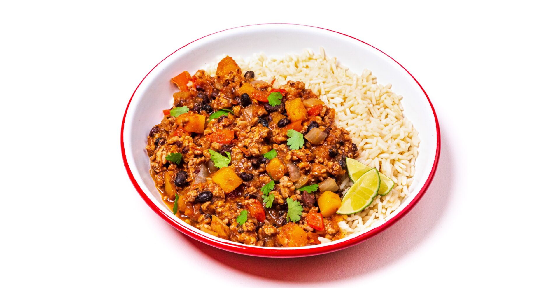 Chilli con carne with rice in a red and white bowl