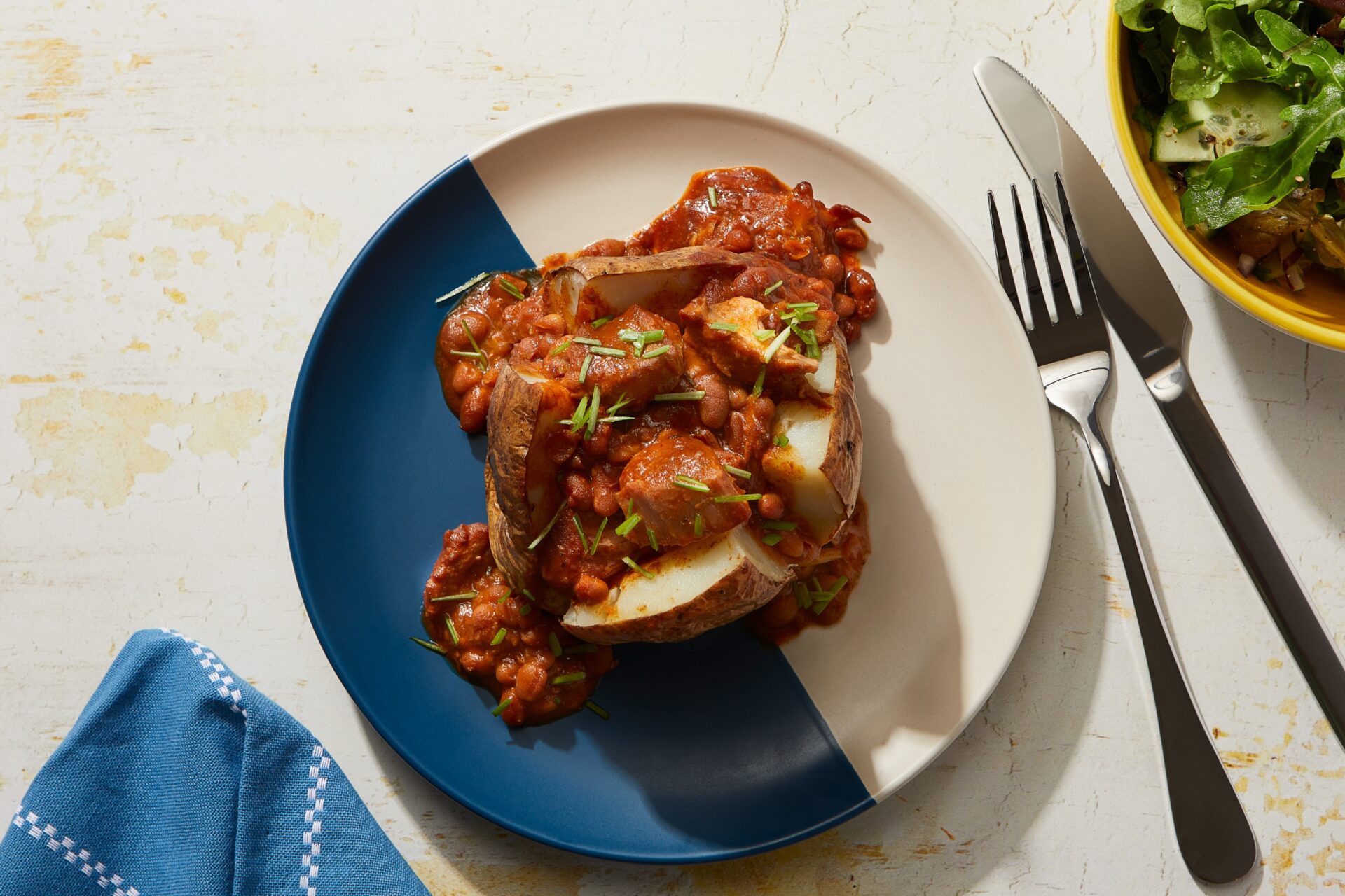 Slow cooked pork and bbq beans served in a jacket potato