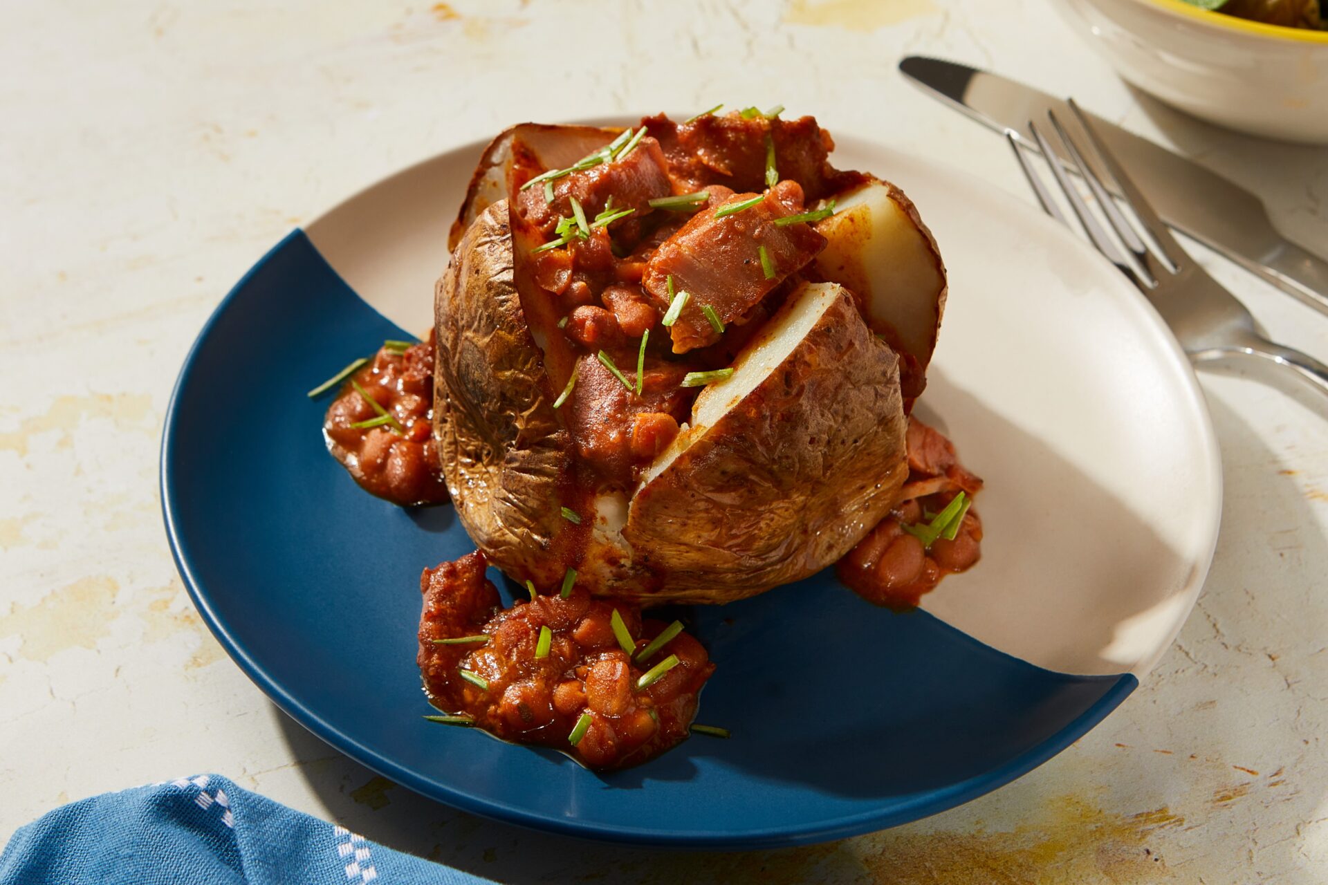 Slow cooked pork and bbq beans served in a jacket potato