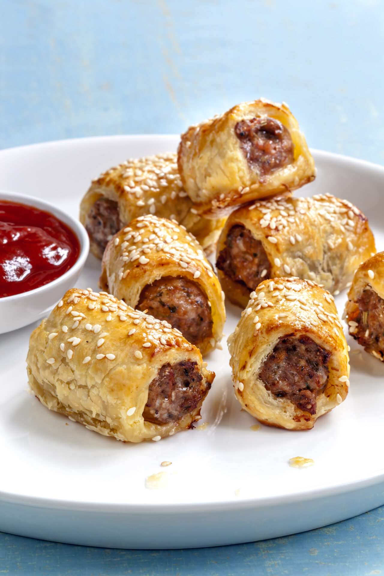 Pork and Apple `Sausage’ Rolls on a plate with ketchup